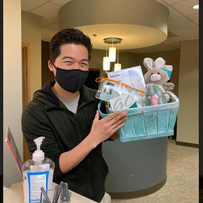 patient receiving a gift basket after cosmetic dentistry procedure at Renton Smile Dentistry